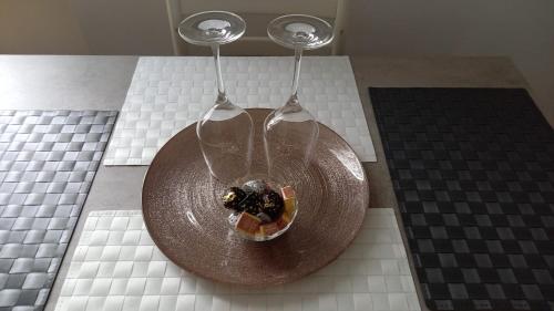 two wine glasses with food in a bowl on a table at TERRAZZA SUL MARE IN VIA DEVOTO in Chiavari