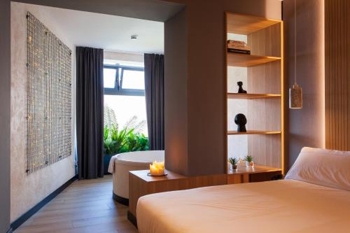 a bedroom with a bed and a room with a window at Hospedium H Cabo Sport in Finisterre