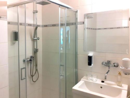 a bathroom with a shower and a sink at Hotel Casanova in Duchcov