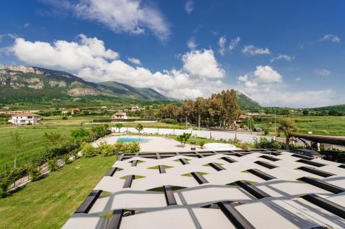 an overhead view of a building with a pool and mountains at Villa Eleonora Paestum in Paestum