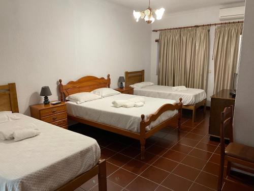 a bedroom with two beds with white sheets at Kualquer Koisa in Tondela