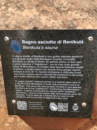 a sign on the side of a rock at La Grotta di benikula' in Pantelleria