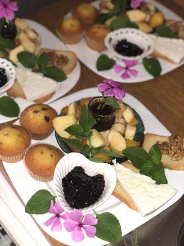 a table topped with plates of pastries and desserts at Vila Isufaj in Vlorë