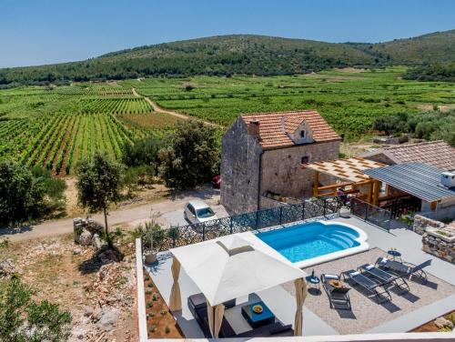 an external view of a villa with a swimming pool at Stone House Prapatna in Smokvica