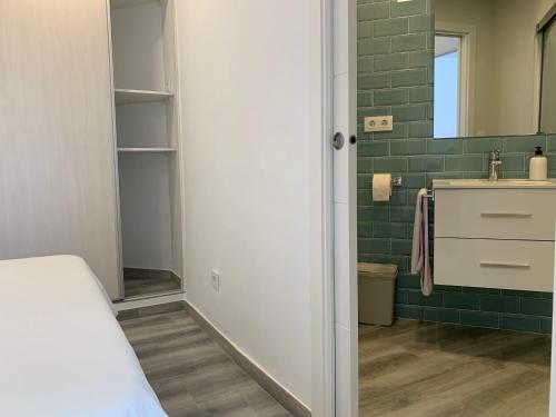 a small bathroom with a sink and a mirror at Apartamentos Villa Pirata Tarifa in Tarifa