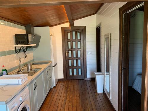 a kitchen with a sink and a washer at Apartamentos Villa Pirata Tarifa in Tarifa