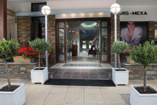 a lobby of a building with potted plants in pots at Kymata in Paralia Katerinis