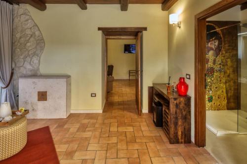 a living room with a wood floor and a fireplace at Borgo Incantato Spoleto in Pompagnano