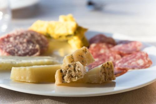 a plate of different types of cheese on a table at Borgo Incantato Spoleto in Pompagnano
