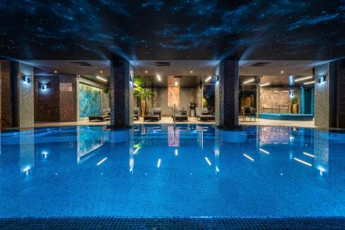 a swimming pool in a hotel at night at Kravt Nevsky Hotel & Spa in Saint Petersburg