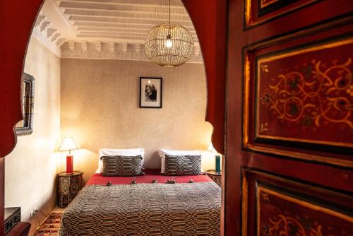 a bedroom with a bed with two pillows on it at Riad Spa Sindibad in Marrakesh