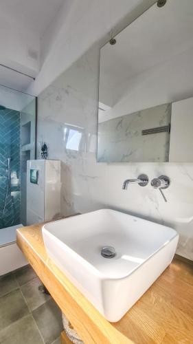 a bathroom with a white sink and a mirror at The "Perfect Beach House" Villa in Lachania