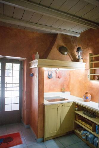 a kitchen with yellow cabinets and a sink in it at Skinos House in Vari