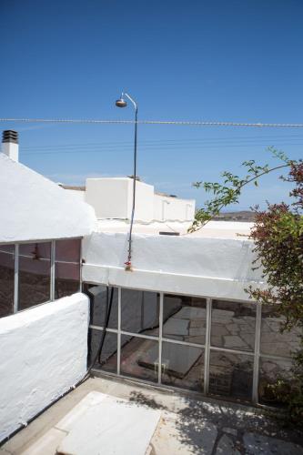 a white building with a street light on top of it at Skinos House in Vari