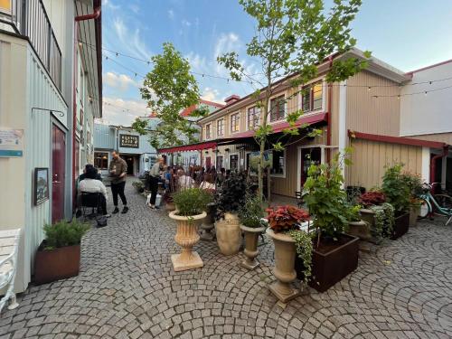 a street with a bunch of potted plants on it at Fyrvägen 13 'Ydermossa' NEW! in Munka-Ljungby