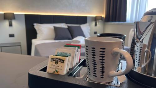 a tray with a coffee cup on a table in a hotel room at Tranquillo UpTown Lecce in Lecce