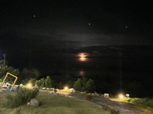 a night time view of a street with a moon at 三仙台星辰民宿 in Chenggong