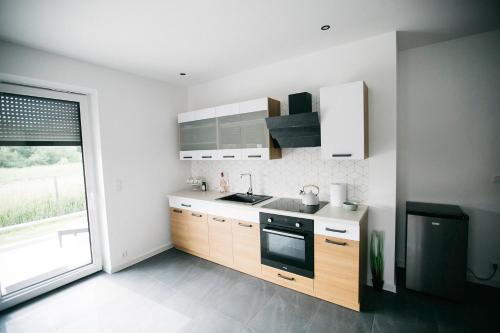 A kitchen or kitchenette at Apartamenty Perła Orawy