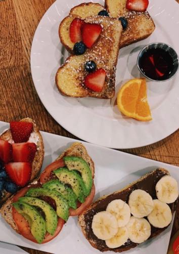two plates of breakfast foods with fruit and toast at Fairholm Boutique Inns in Charlottetown