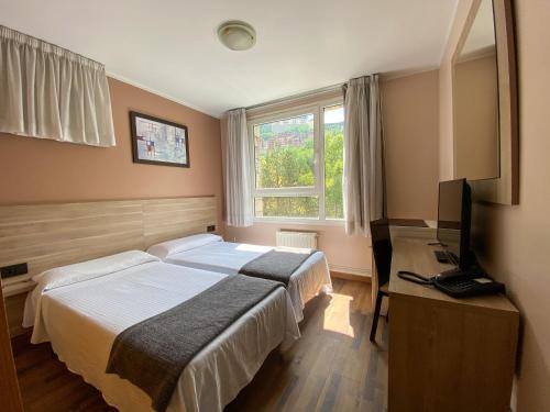 Somriu Hotel Vall Ski tesisinde bir odada yatak veya yataklar