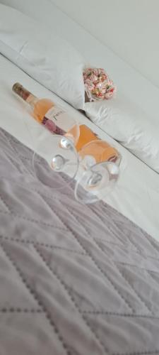 a bottle on a bed with at Stipe Residence in Podstrana