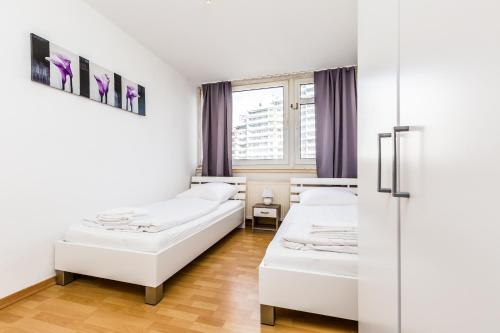 a room with two beds and a window at Work & stay apartment in Bergisch Gladbach Bensberg in Bergisch Gladbach