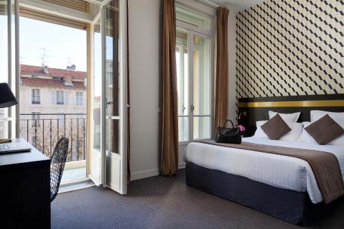 Ein Bett oder Betten in einem Zimmer der Unterkunft La Malmaison Nice Boutique Hôtel