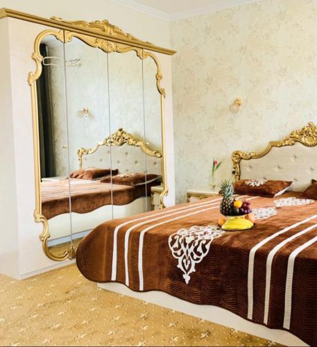 a bedroom with a bed with a large mirror at VitaPark Stariy Dub in Truskavets