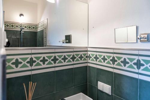 a bathroom with a toilet and a mirror at Bergvilla Oberon - Your Austrian Home in Bad Aussee