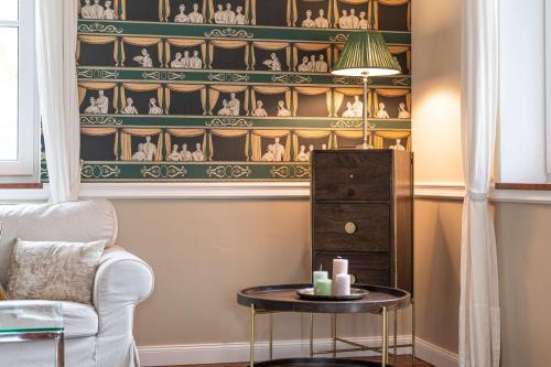 a living room with a table and a shelf with figurines at Bergvilla Oberon - Your Austrian Home in Bad Aussee