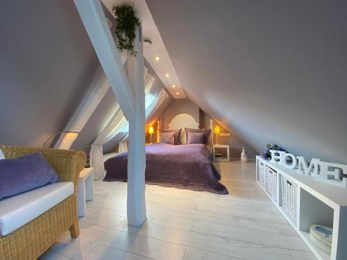 a attic bedroom with a bed and a couch at Haus Christine in Traben-Trarbach in Traben-Trarbach