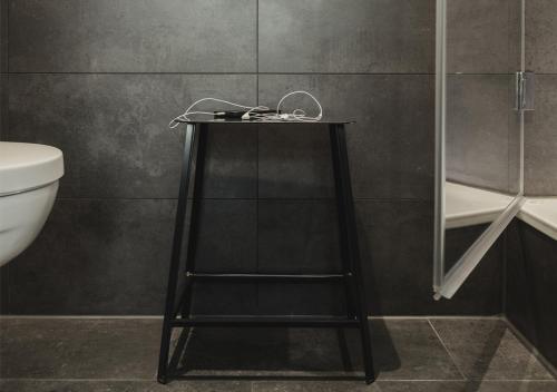 a black table in a bathroom with a toilet at Pyjama Park St Pauli Hotel und Hostel in Hamburg