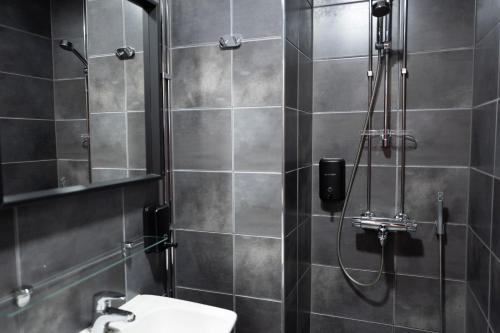 a bathroom with a shower with a toilet and a sink at Hotel Finn in Helsinki