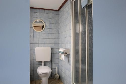 a bathroom with a toilet and a shower at Hotel Arosa in Zandvoort