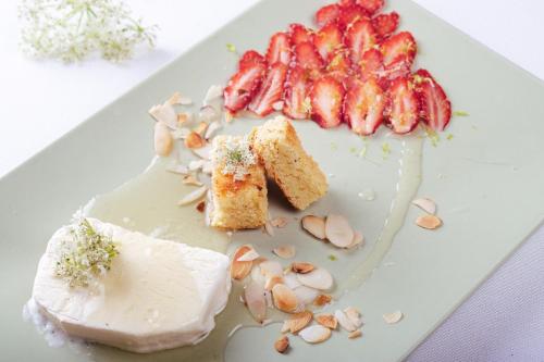a plate of food with strawberries and nuts on it at Hôtel & Restaurant de la Plage in Crozon