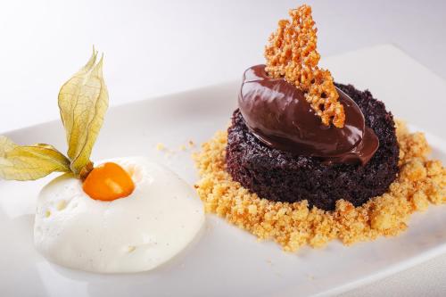 a piece of chocolate cake and a egg on a plate at Hôtel & Restaurant de la Plage in Crozon