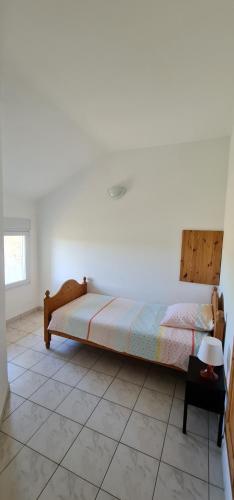 une chambre avec un lit et un sol carrelé dans l'établissement Mas 9 Personnes avec piscine, à Jonquières