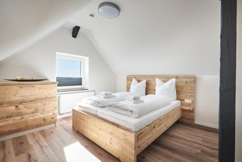 a bedroom with a wooden bed and a window at Smart Resorts Haus Saphir Ferienwohnung 511 in Winterberg