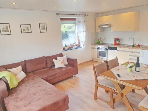 a living room with a couch and a table at Ferienwohnung Sonnenblick in Edersee