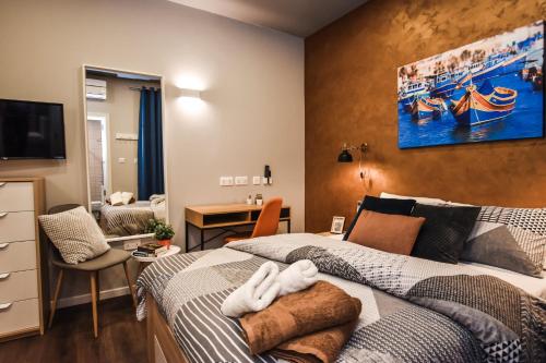 a bedroom with two beds and a living room at Cosy Albert's Seaside Suites (Sliema) in Sliema