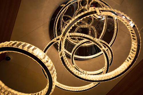 a large white chandelier hanging from a ceiling at Hotel Xcell 広島 流川通り in Hiroshima
