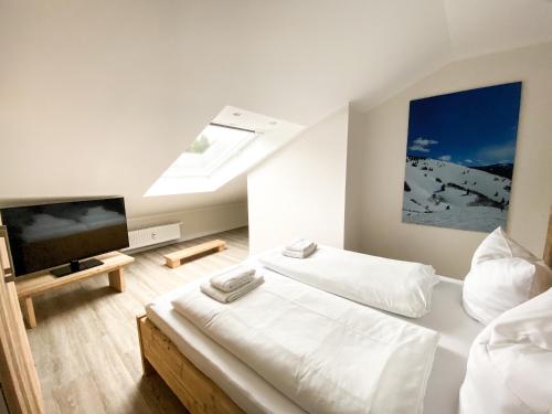 a bedroom with two beds and a flat screen tv at Smart Resorts Haus Azur Ferienwohnung 812 in Winterberg