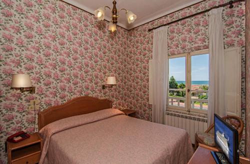 Postel nebo postele na pokoji v ubytování Hotel Villa Flores