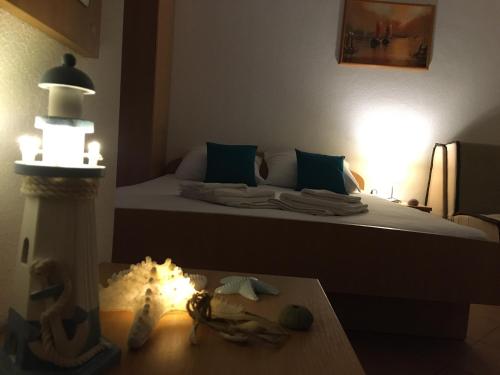 a room with a bed with a lighthouse and a table at Apartments MAMPAS in Neum