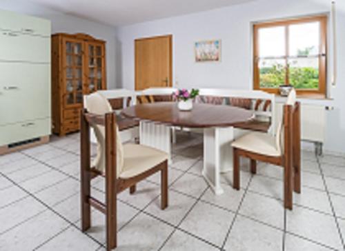a kitchen with a dining room table and chairs at Eulenberghof Kraus in Altenkunstadt