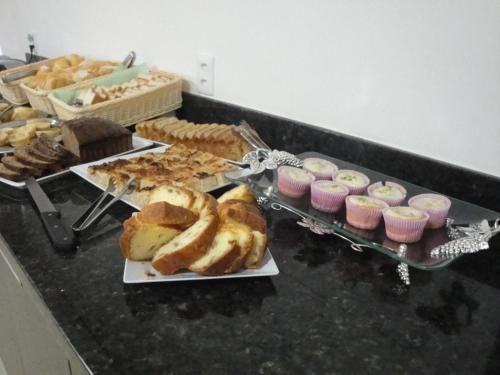 a buffet of pastries and pastries on a table at Jalapão Hotel in Palmas