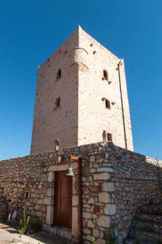 a brick building with a bell on top of it at Kamares Villas in Kamáres