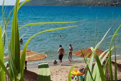 a group of people swimming in the water at the beach at Kamares Villas in Kamáres