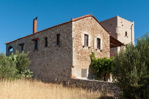 a brick building with a tower on top of it at Kamares Villas in Kamáres