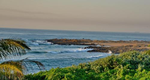 a view of a beach with the ocean at Pumula Beach Hotel in Umzumbe